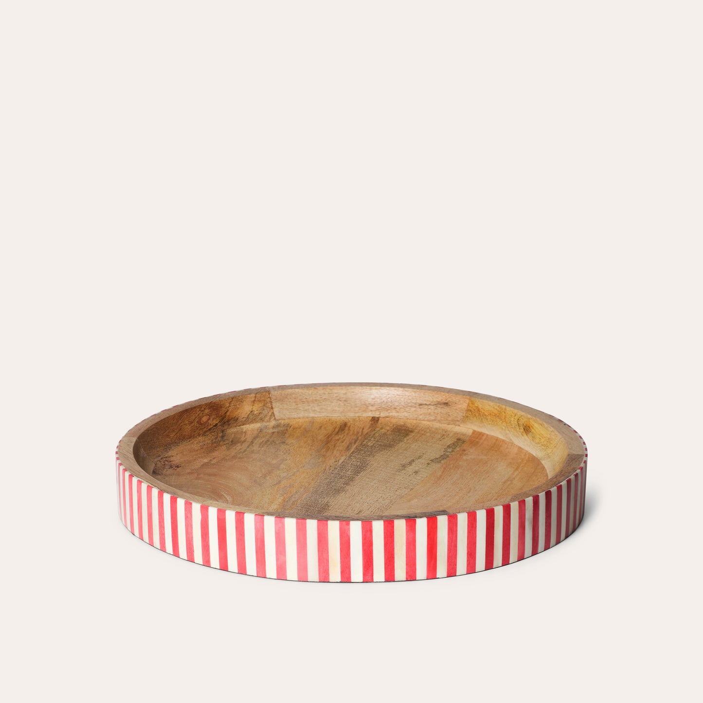 A round wooden tray with red and white striped bone inlay along the edge.