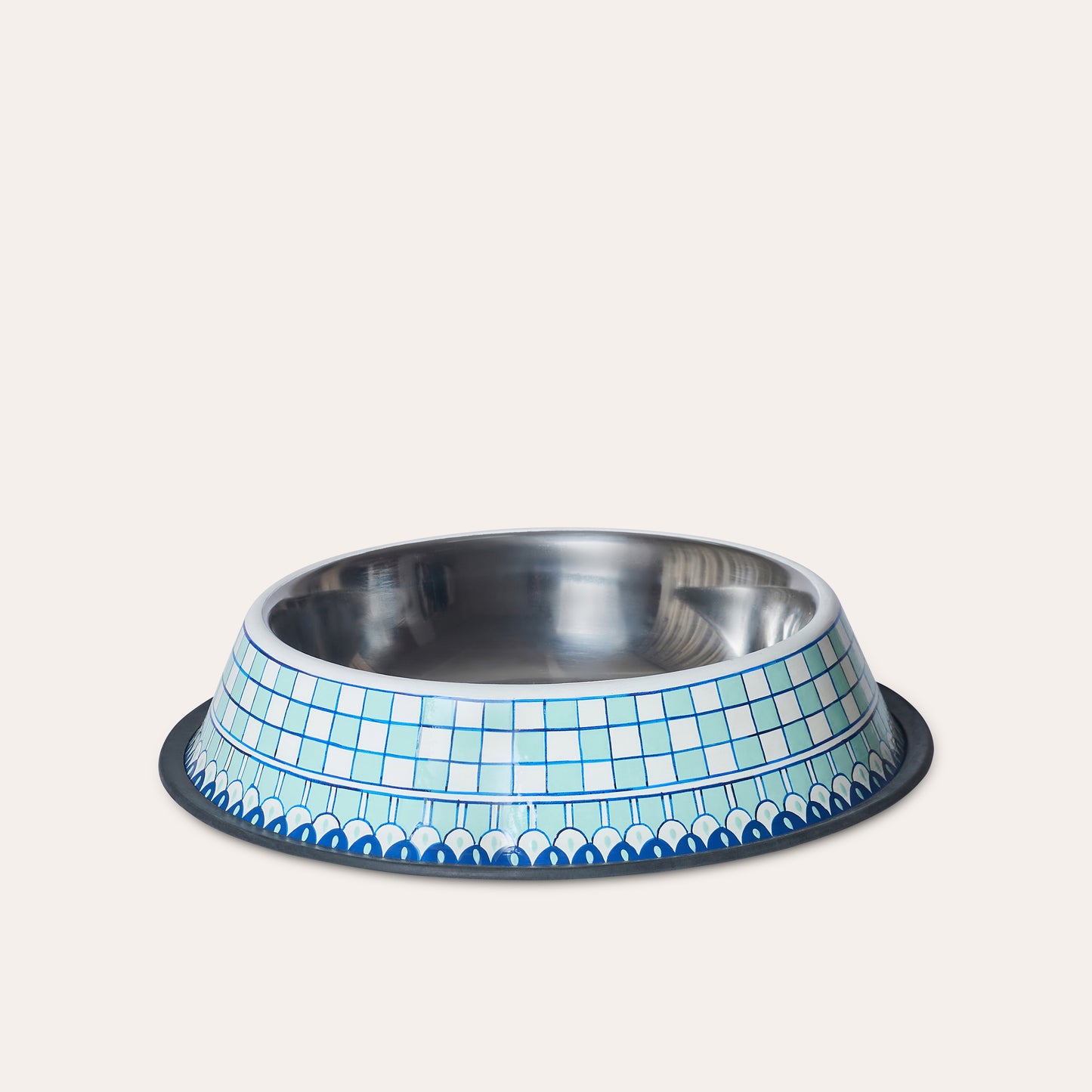 Cutout of a stainless steel pet feeder with chequered harlequin pattern painted in white, aquamarine and blue.