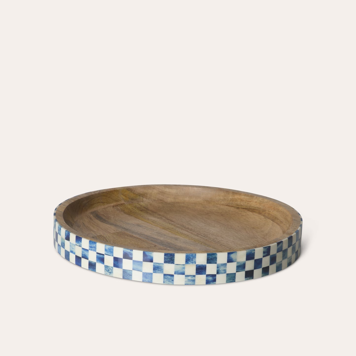 Circle round wooden tray with a blue and white checkered border on a white background.