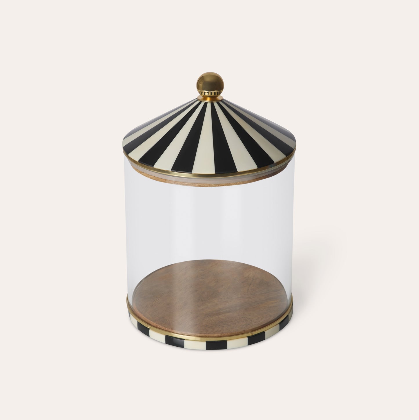 Decorative glass jar with black and white striped lid on a white background