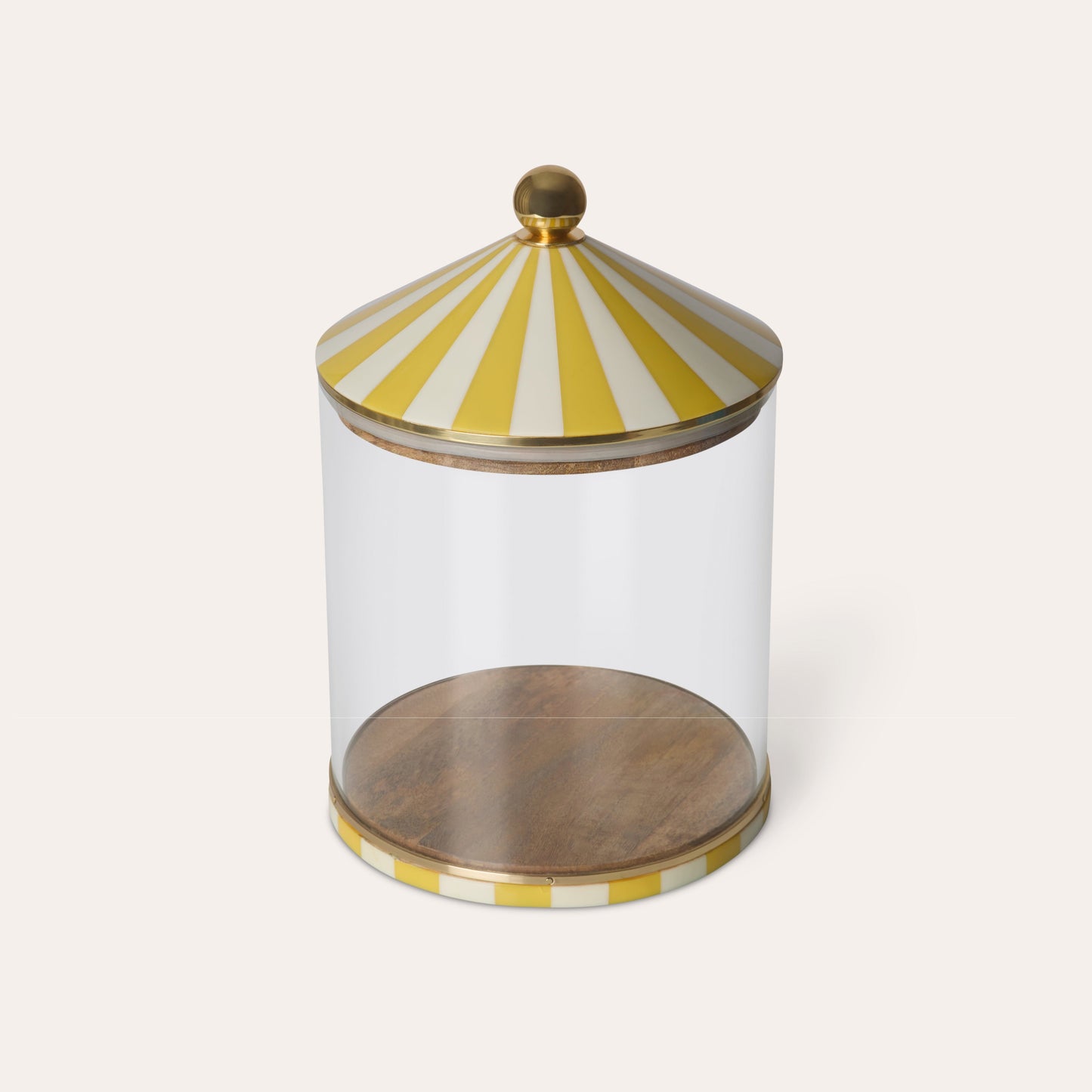 Glass jar with a yellow and white striped lid on a white background