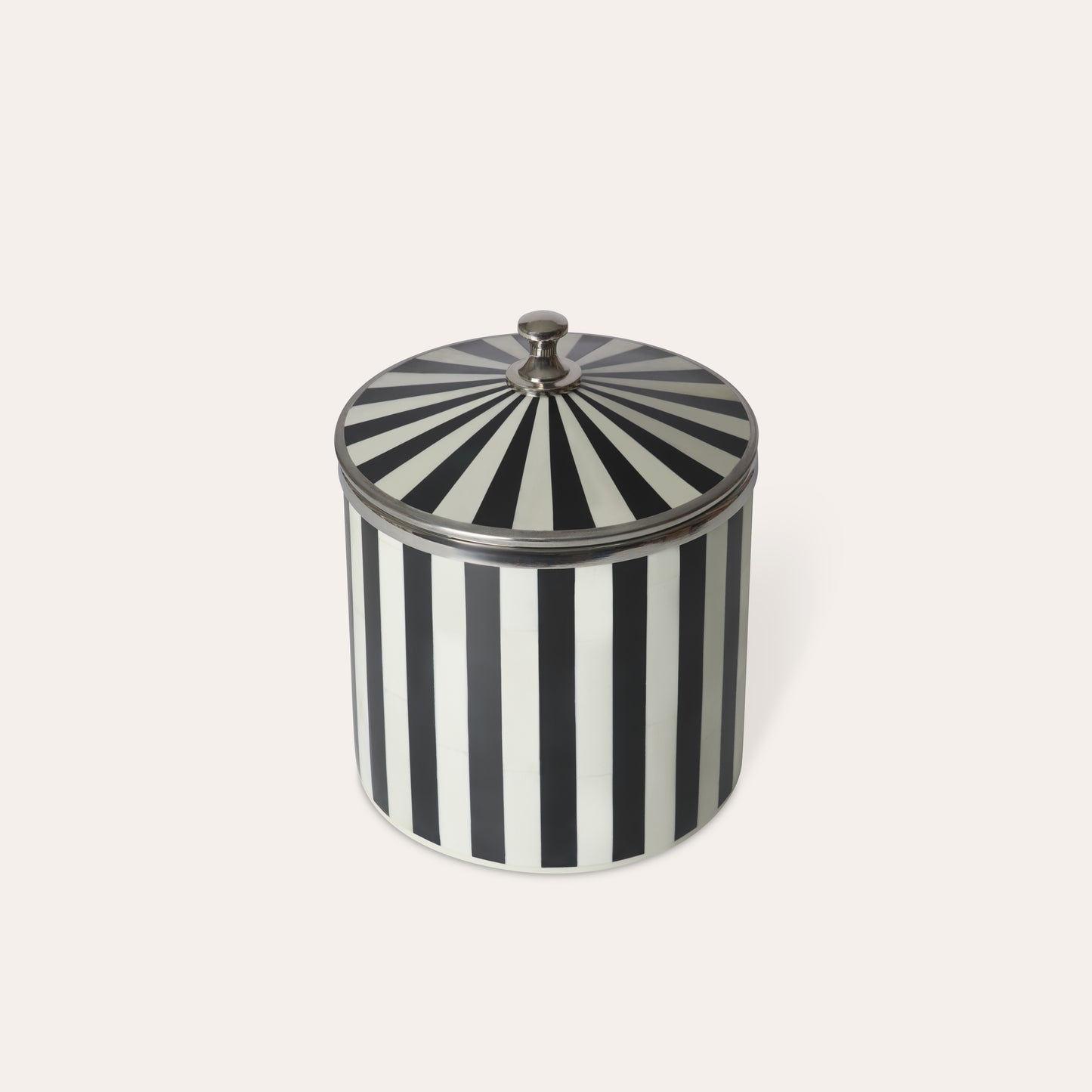 Black and white striped circular ice bucket with a lid, chrome silver details handle and edges on a light background.