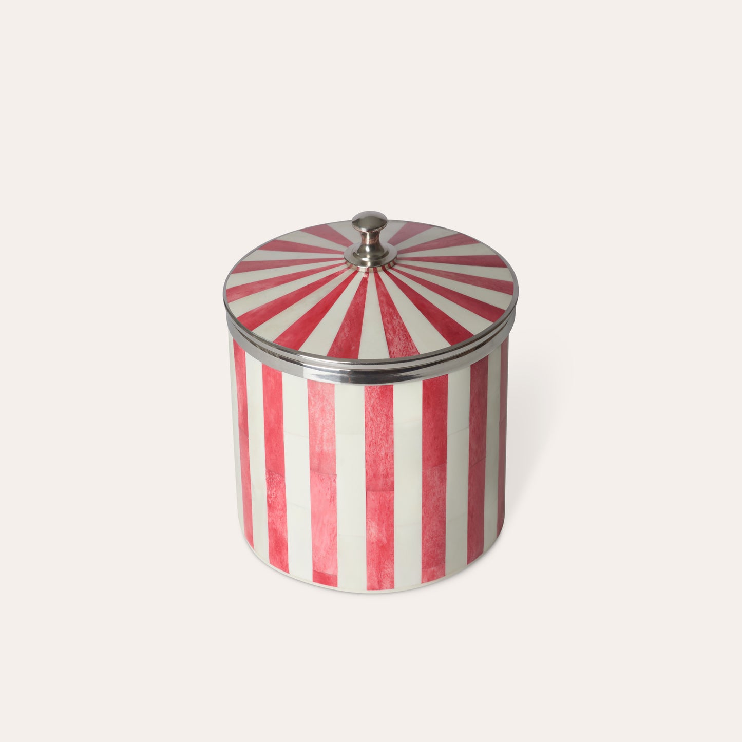 Red and white striped ice bucket with a chrome silver lid on a light beige background.