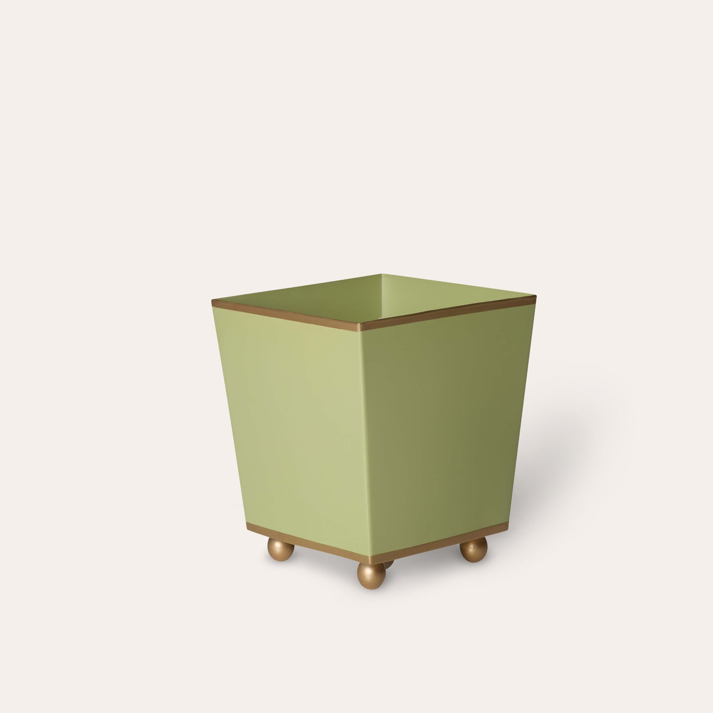 Green cube planter with gold accents on a white background