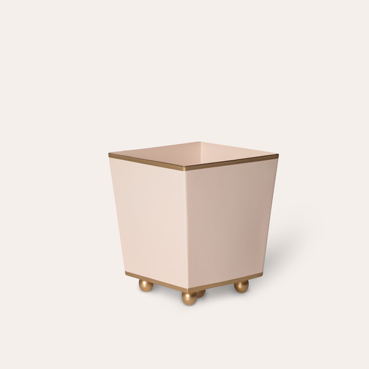 Square metal trash can with a pinkish-beige color on a white background.