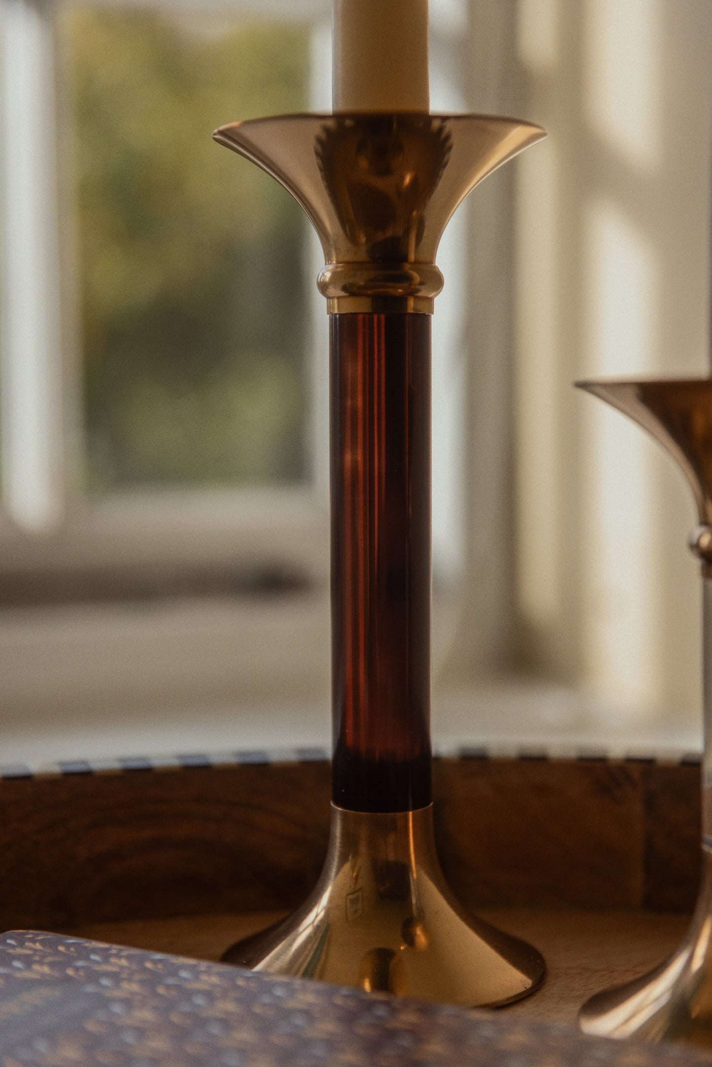 Close-up of a brass candlestick with a blurred background.