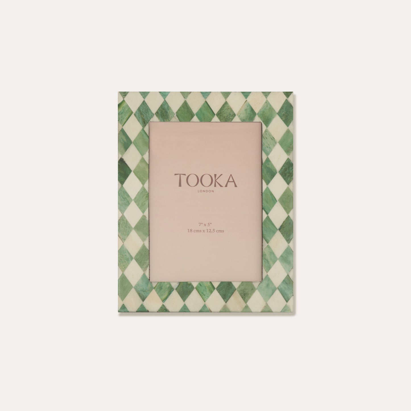Green and white checkered photo frame with 'TOOKA' branding on a light beige background