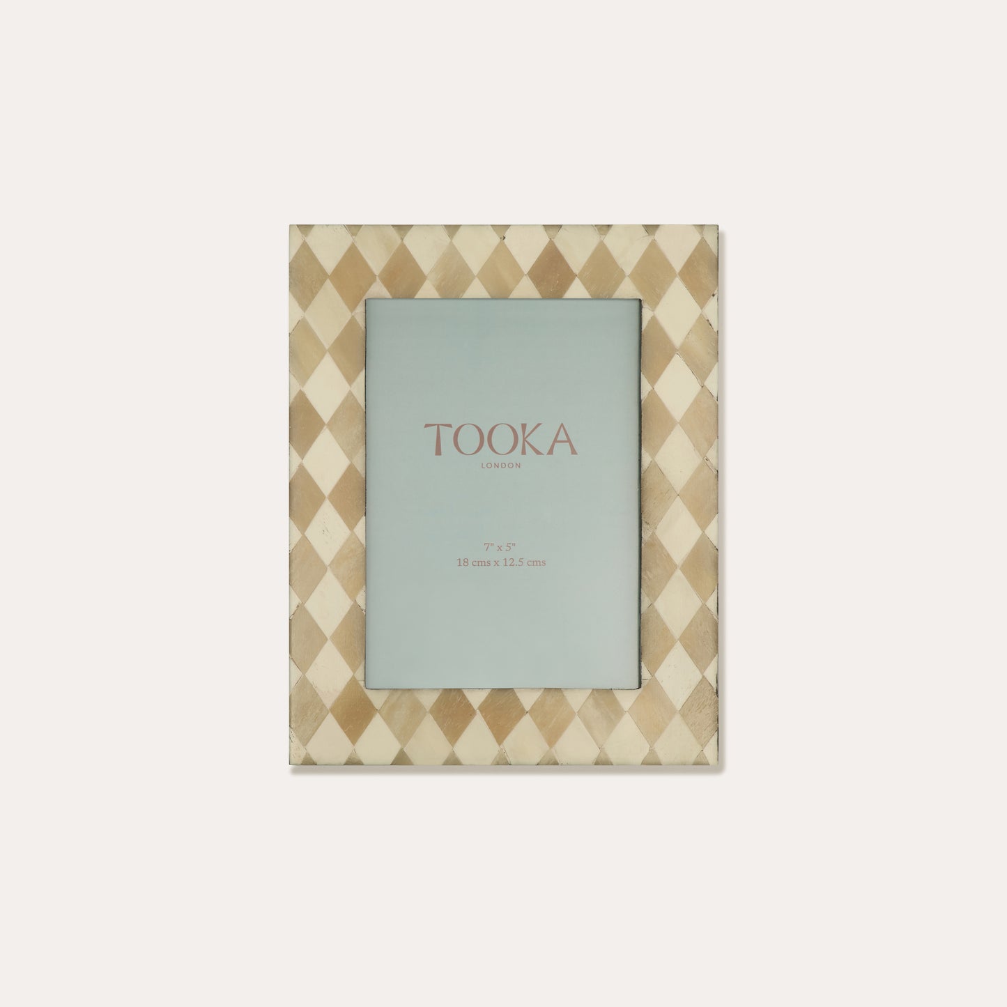 Patterned photo frame with 'Tooka' branding on a white background