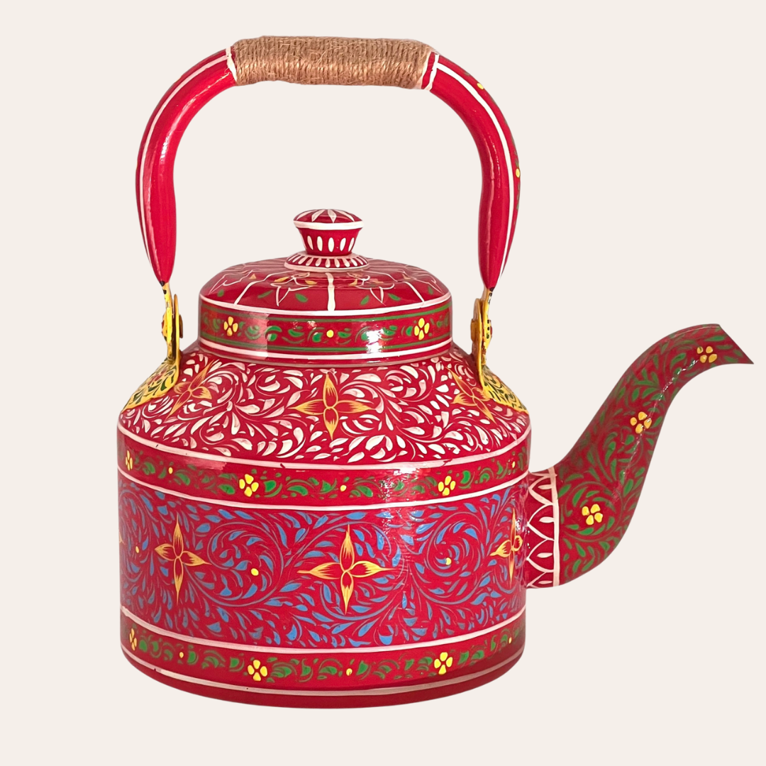 A red hand painted stainless steel teapot stove kettle with a floral pattern and a twine wrapped handle.