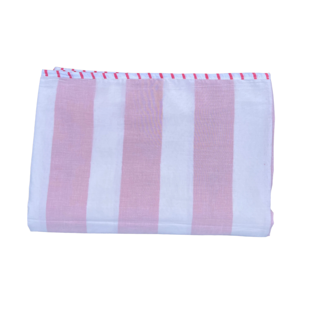 Folded striped cotton blanket in pink and white stripes with a decorative stitched edge trim in the same colour.