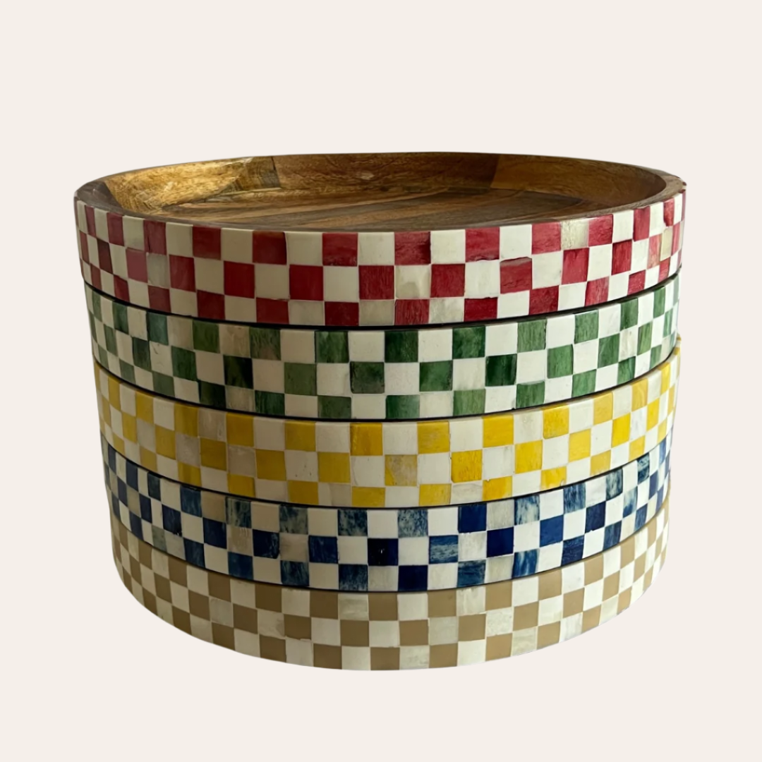 5 trays stacked on top of each other, all checkered, one with red, another with green, yellow, blue and beige.