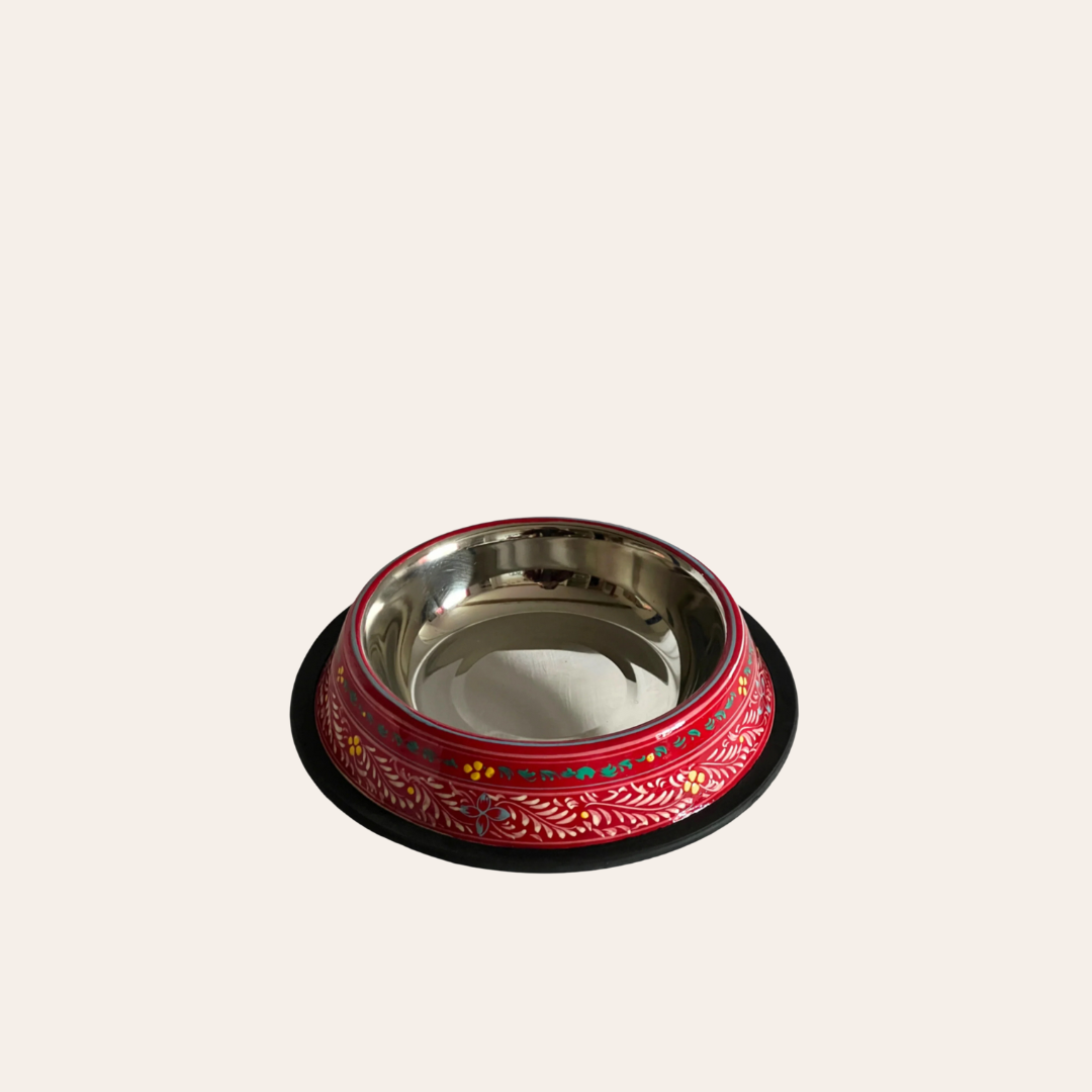 Cutout of a stainless steel pet feeder fire engine red base colour with hand painted delicate floral pattern.