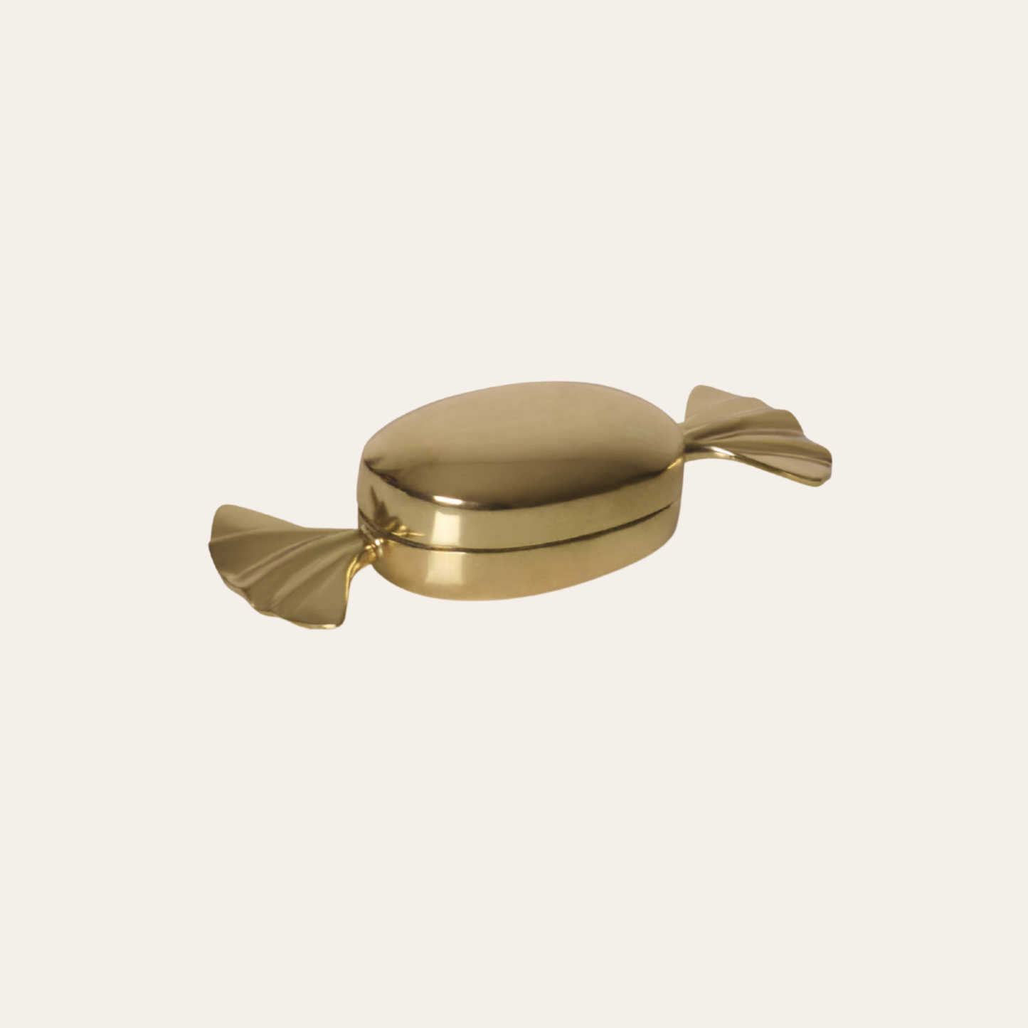 Gold candy-shaped trinket box on a white background