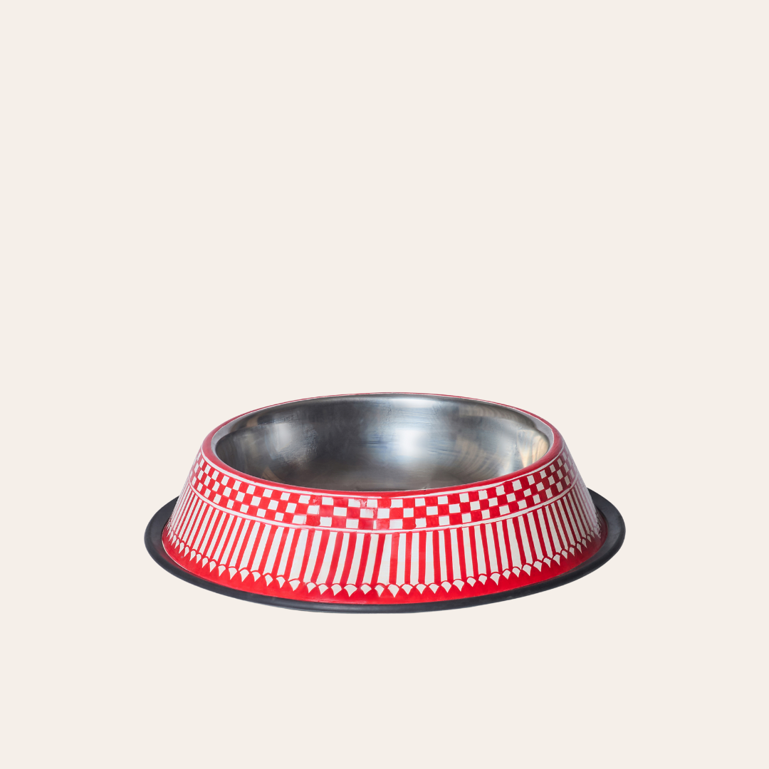 Stainless steel pet feeder with red and white checkered pattern on a light beige background.