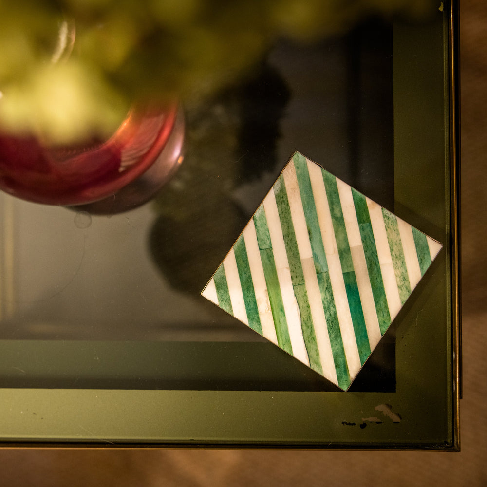 Decorative item with a striped pattern on a reflective surface