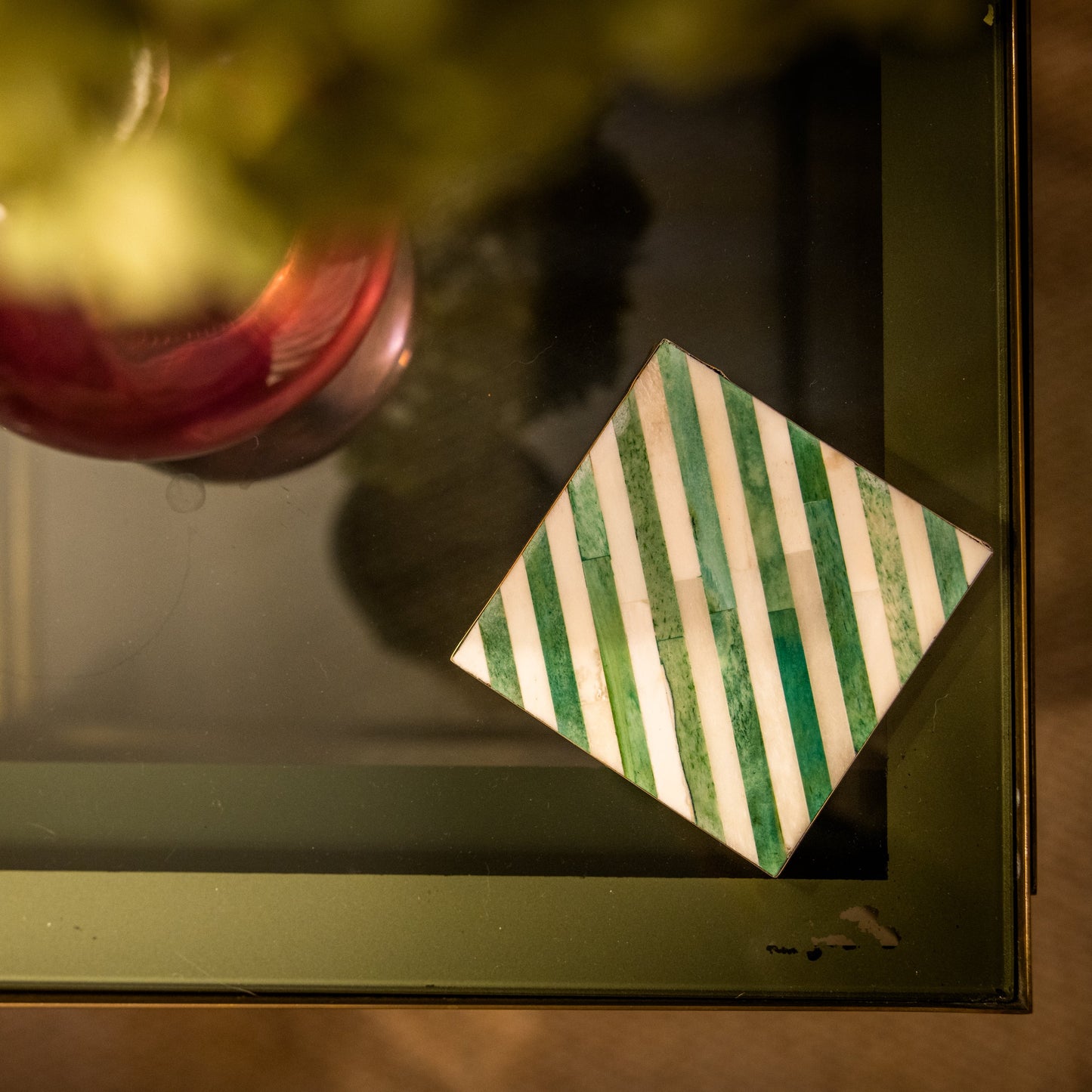 Decorative item with a striped pattern on a reflective surface