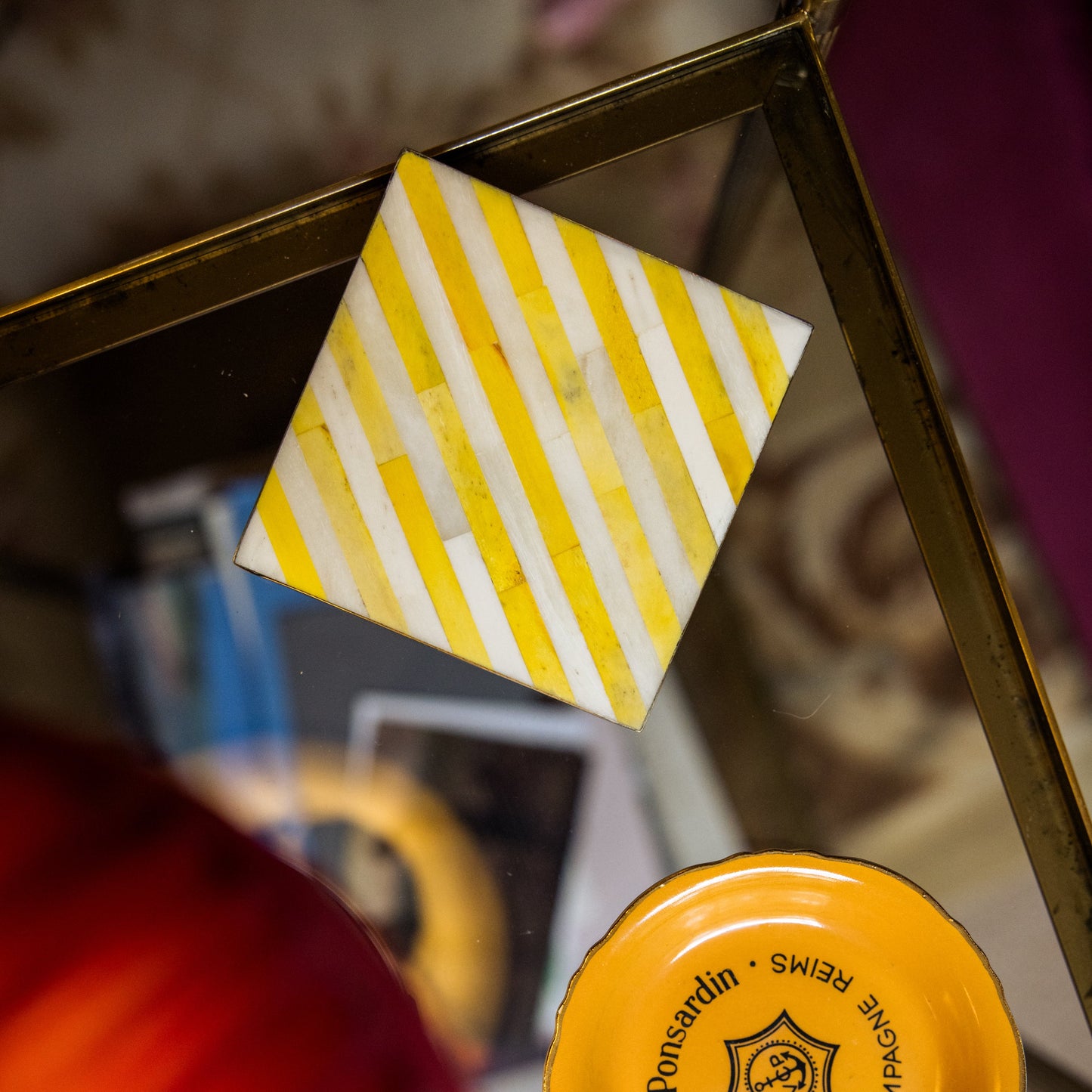 Close-up of a yellow cap with branding on a reflective surface