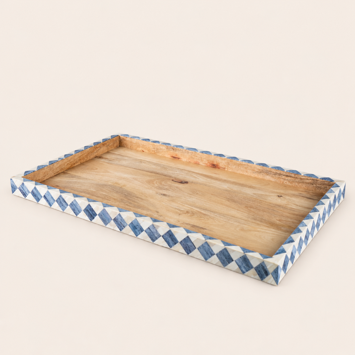 A rectangular wooden serving tray with a natural wood grain interior and a decorative border featuring a blue and white diamond pattern, shown on a solid light beige background.