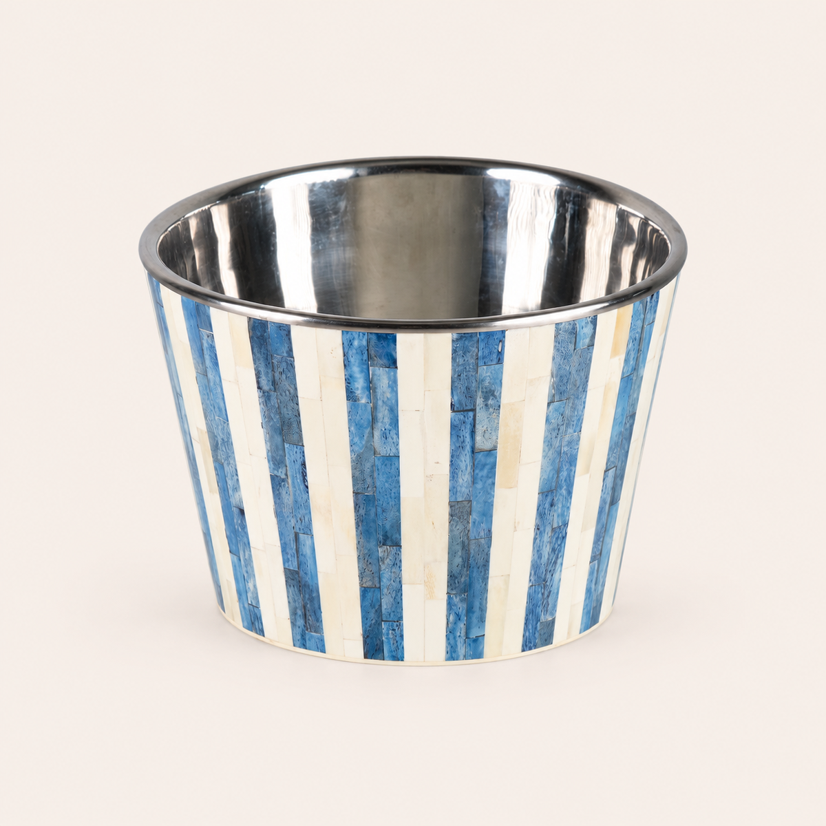 A small cylindrical metal cup or planter with a blue and white striped exterior and a polished silver interior, shown on a plain light beige background.