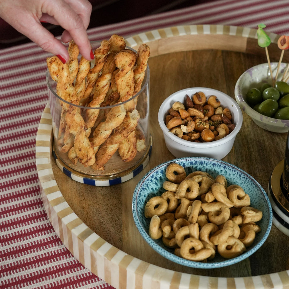Snack platter with various types of snacks on a wooden table.