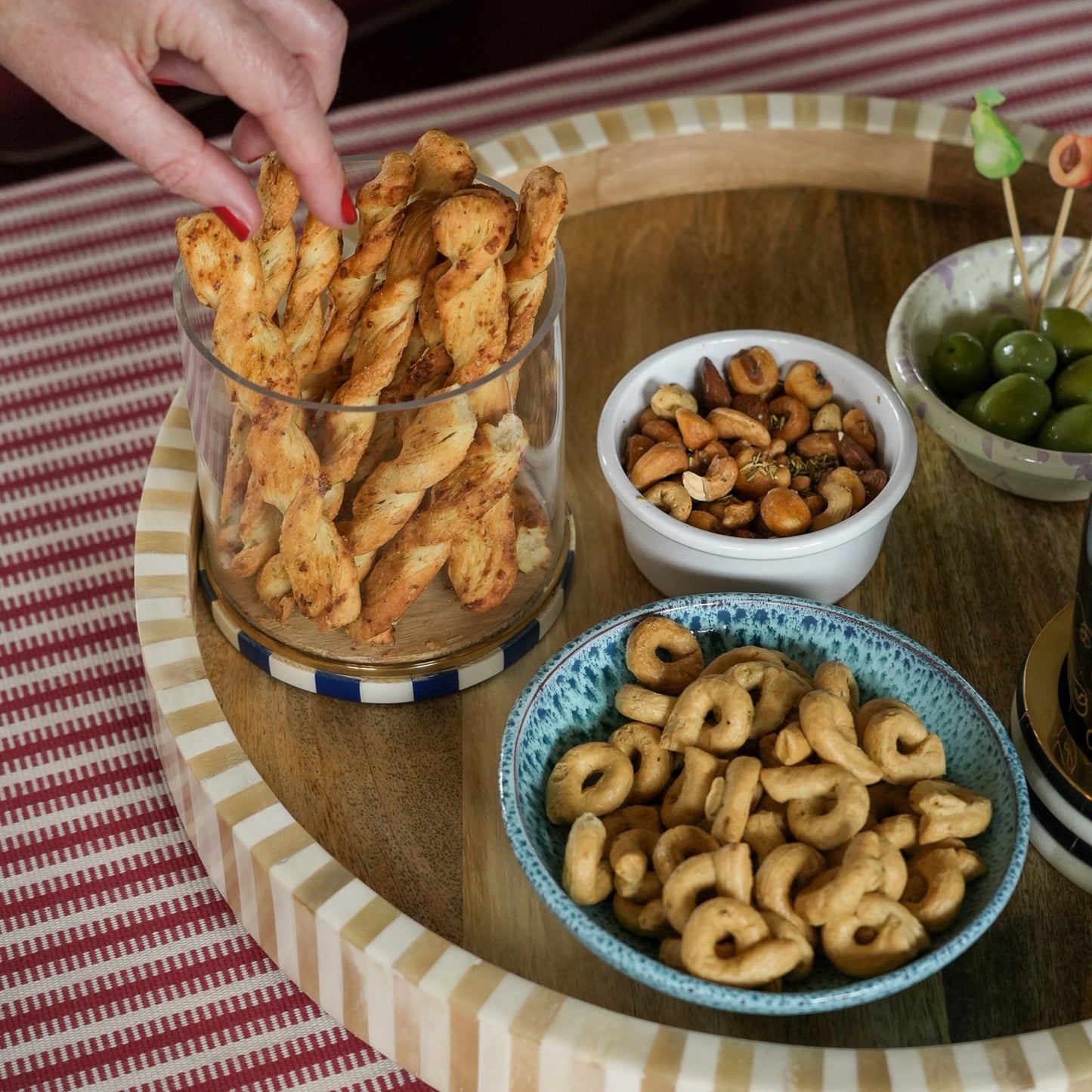 Snack platter with various types of snacks on a wooden table.