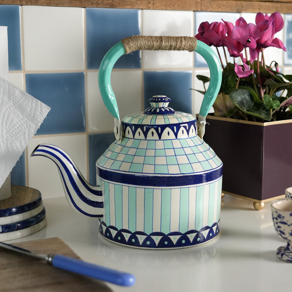 Ceramic teapot with blue and green pattern on a kitchen counter