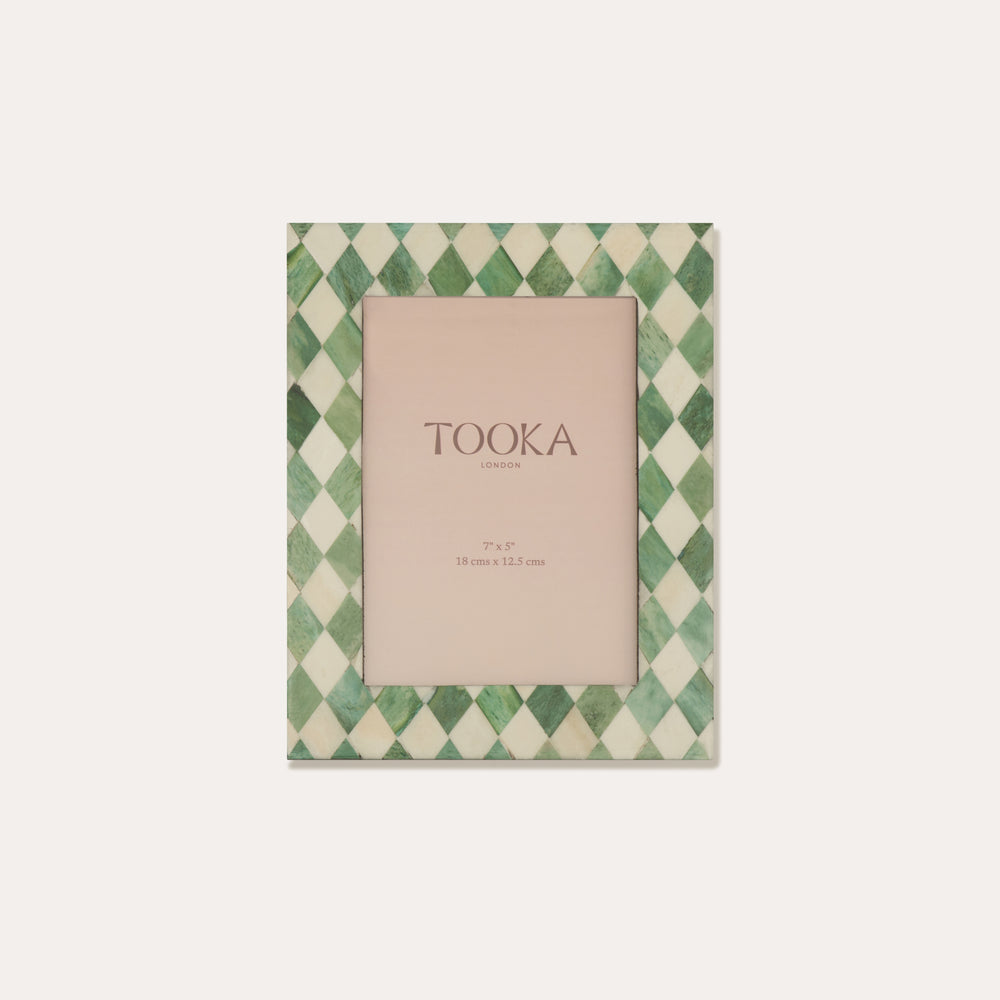 Green and white checkered photo frame with 'TOOKA' branding on a light beige background