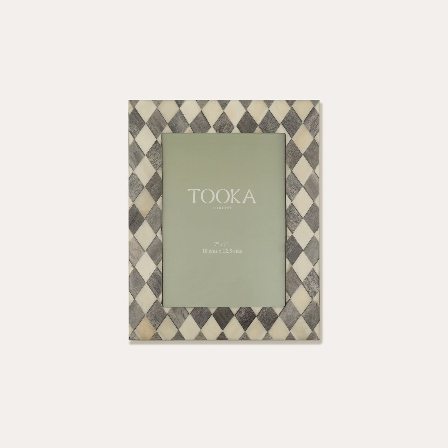 Checkered photo frame with a green card inside on a white background