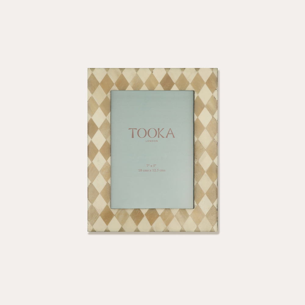 Patterned photo frame with 'Tooka' branding on a white background