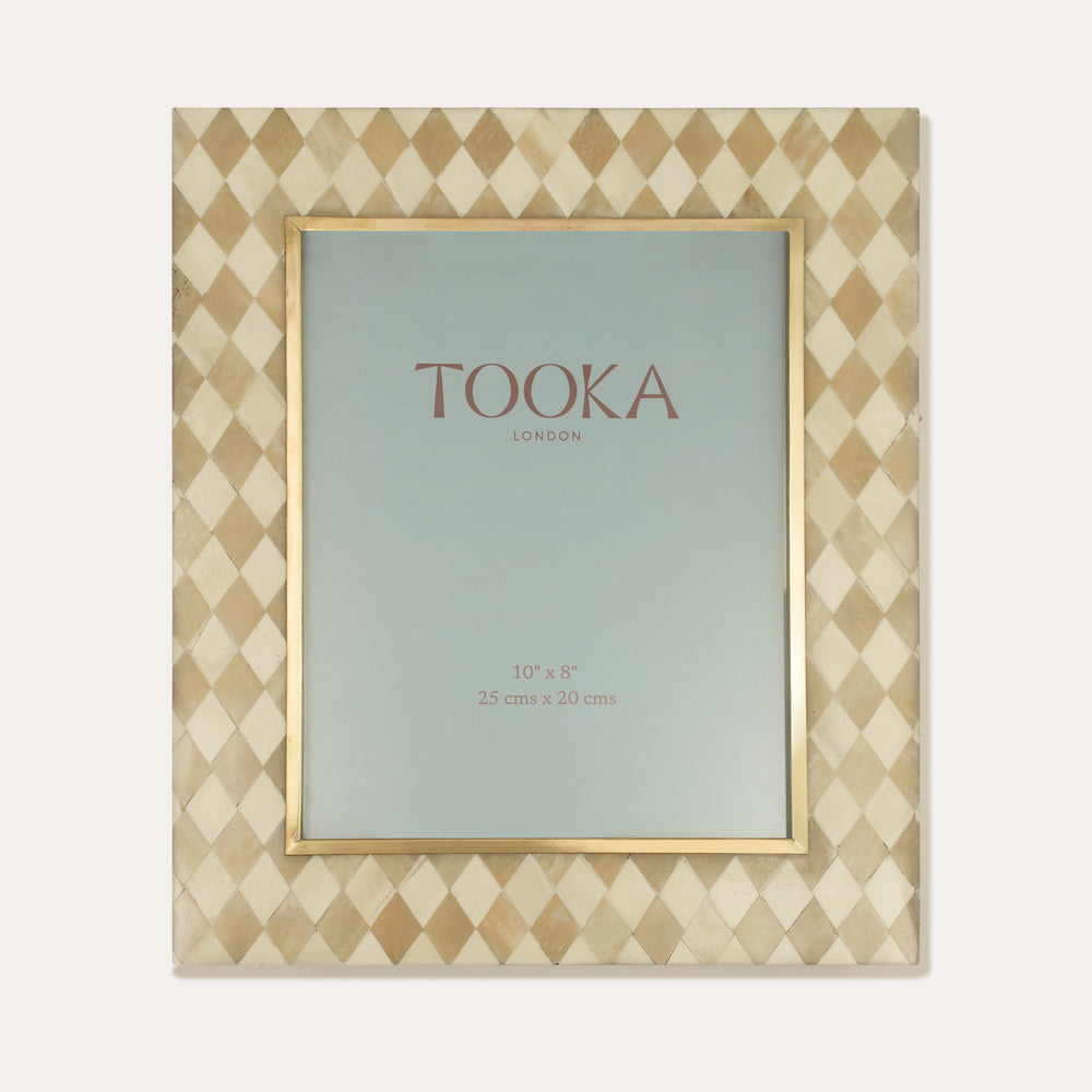 Decorative picture frame with diamond geometric pattern and 'Tooka' branding on a white background